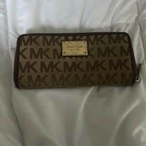 Michael Kors wallet brown beige zip around logo on front with gold bar